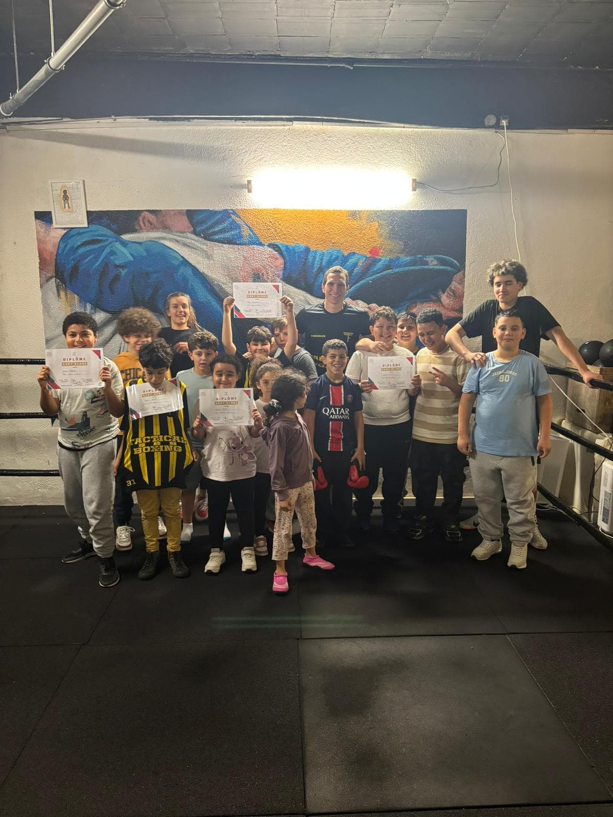 Les enfants de la boxe éducative avec leur diplôme Gant blanc, autour de leur coach